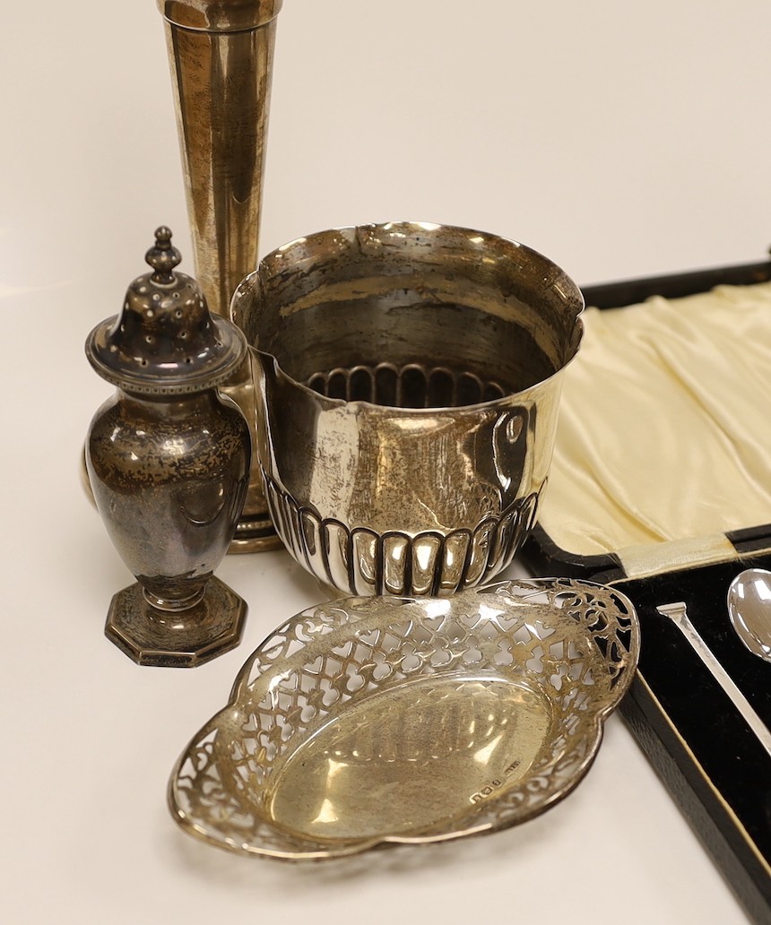 A pair of George V silver mounted candlesticks, weighted, 19.7cm, a silver vase, two pierced silver small dishes, a silver mounted penknife, George III silver spoon, a silver pepperette, pair of silver tongs, silver salt